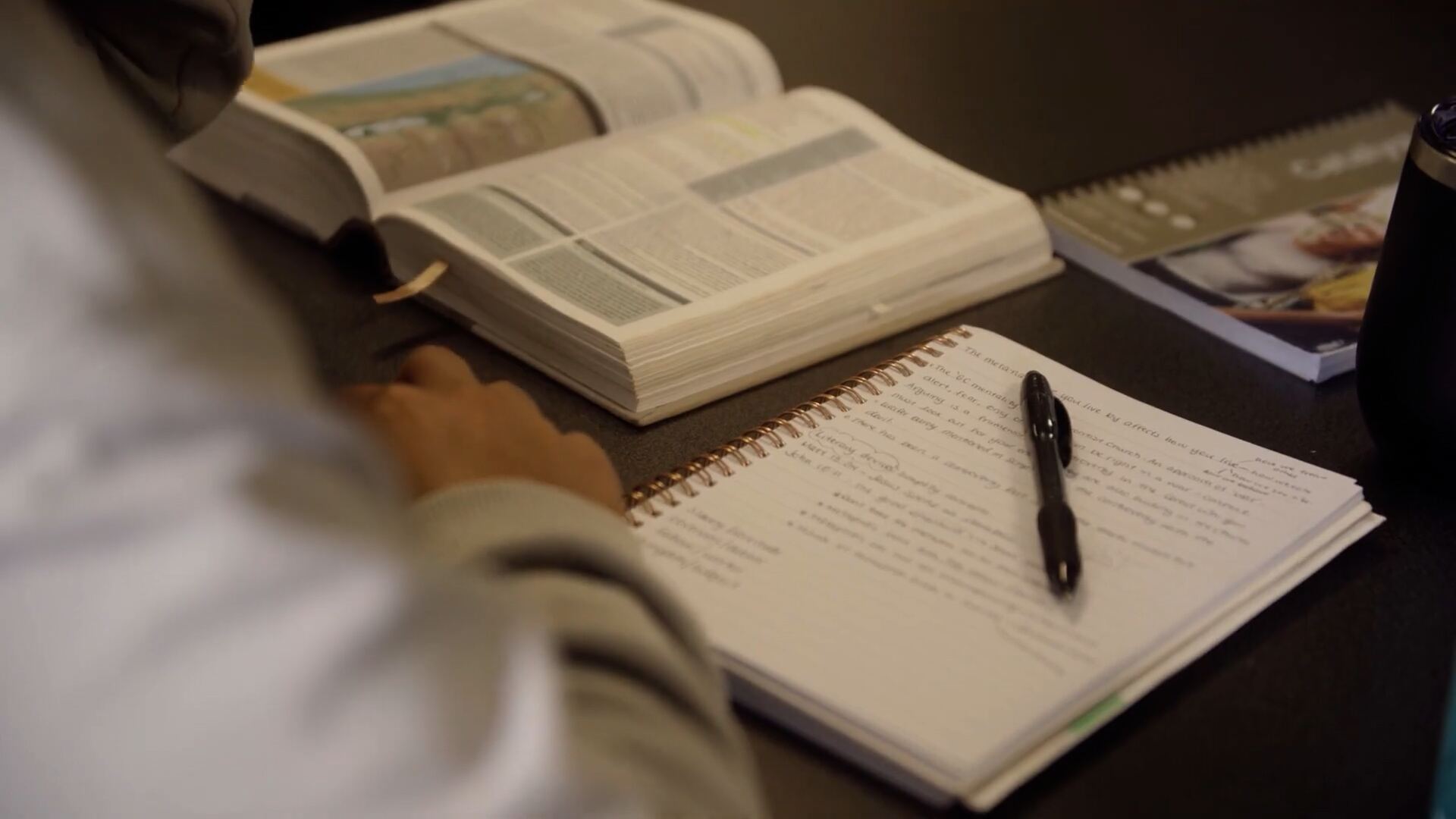 An open Bible and journal during study