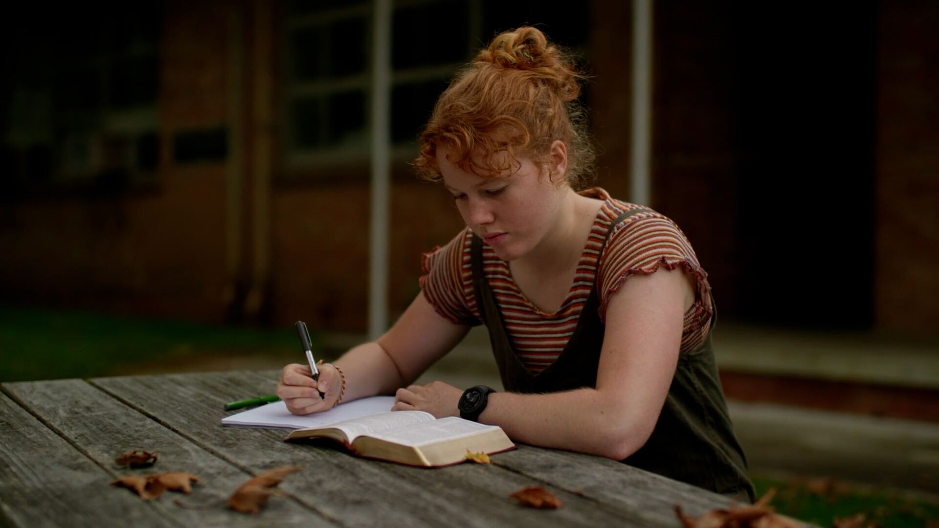 A Catalyst student journaling with an open Bible